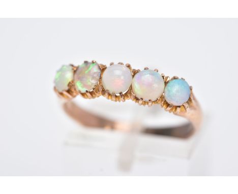 A YELLOW METAL FIVE STONE OPAL RING, designed with a row of five circular cut opal cabochons, plain polished band, ring size 