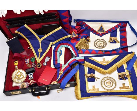A CASE OF MASONIC REGALIA, a black case opens to reveal Masonic regalia such as two silver fob medals, a quantity of other ye