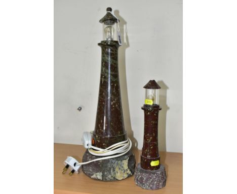 TWO CORNISH SERPENTINE TABLE LAMPS IN THE FORM OF LIGHTHOUSES, the smaller lamp lacks wiring and has damage to the shade and 