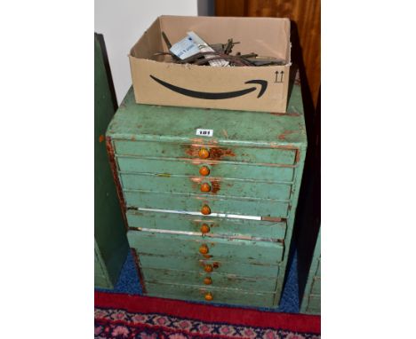 A LATE 19TH CENTURY PINE BANK OF TEN LONG GRADUATED DRAWS, partially painted green, some draws with dividers, fitted with amb