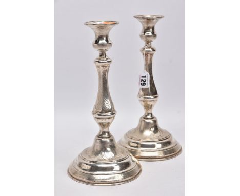 A PAIR OF LATE 19TH/EARLY 20TH CENTURY CONTINENTAL WHITE METAL CANDLESTICKS, engine turned and engraved decoration, on shaped