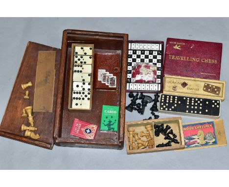 A WOODEN BOX CONTAINING A BOXED SET OF TSL BOXWOOD CHESSMEN, a boxed set of Crystalate dominoes, another boxed set of dominoe
