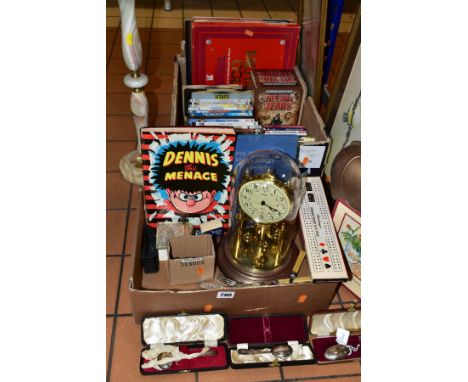 TWO BOXES OF DVD'S, CD'S, SINGLES, LP'S, BOOKS, etc, including a boxed cribbage board, gold plastic piggy bank, a cased silve