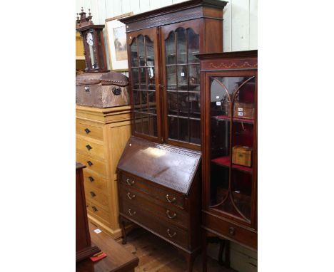 Mahogany Chippendale style bureau bookcase having two glazed panel doors above a fall front with three drawers below on cabri