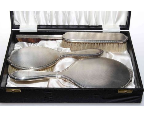 Silver engine-turned four piece brush, comb and mirror set, boxed