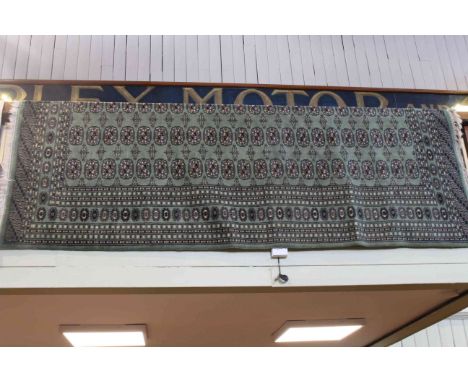 Bokhara carpet with a green ground 2.75 by 1.90