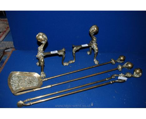 A pair of Brass Fire Dogs with three paw feet and top finial in form of ball and claw along with a matching Poker, Shovel and