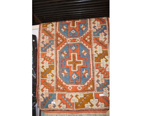 A vintage woollen rug. 1.4 meters x 76cm 