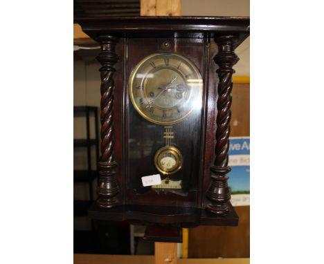 A vintage German wooden cased wall clock 