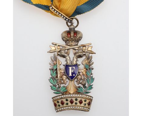 A gilt and enamel Austrian Order suspended from a yellow and blue neck ribbon with a crown above crossed swords and twin-head