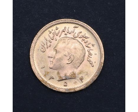 A 1 Pahlavi Iranian gold coin, bare head portrait l. reverse with sword carrying lion before a rising sun. 23mm c8.1g   *Cond
