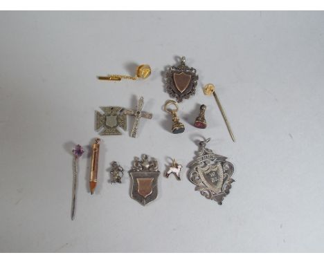 Three Tie Pins (One in the Form of a Swastika) Four Charms, One Stamped 9ct. Three White Metal Sporting Medallions plus one H