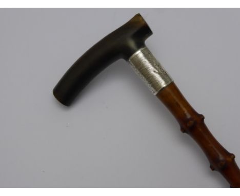 A Thorn Wood Shafted Walking Stick with wide silver band (Birmingham 1918) and horn handle.