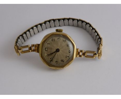 A 9 Ct Gold 375 Hallmark Lady's Vintage Rolex, having a silvered engine turned face, 15 rubies, Rolex movement, case by RWC L