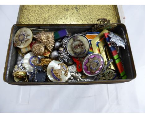 A Tin Containing a Selection of Military Lapel Badges, Fusiliers, RAF, Land Army and Royal Artillery, Devonshire.