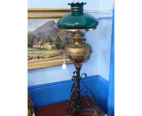 A Brass and Wrought Iron Oil Lamp, with green glass shade, approx 84 cms h.