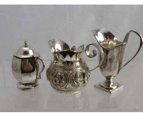 A Solid Silver Mustard Pot, helmet jug and an Indian silver cream jug.