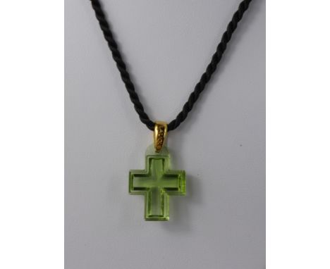 A Lalique Green Glass Cross Pendant, the pendant on silk rope tie, original box and certificate.