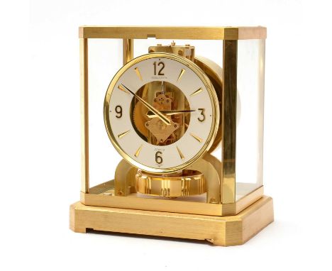 A Jaeger-LeCoultre Atmos clock, of typical design, glazed on all sides with enamelled arabic and arrowhead dial and skeletoni