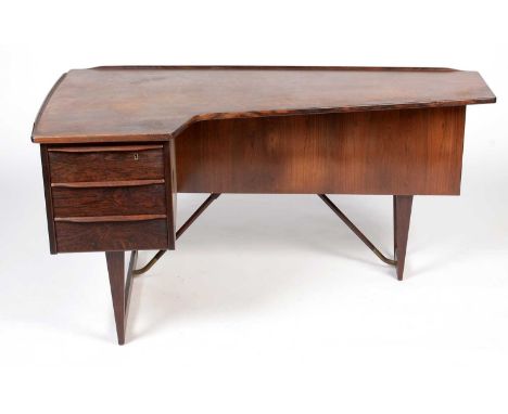 Peter Lovig Nielsen: a rosewood 'Boomerang' desk, with fitted frieze draw, rear shelf and enclosed cupboard, 151 x 88 x 73cms