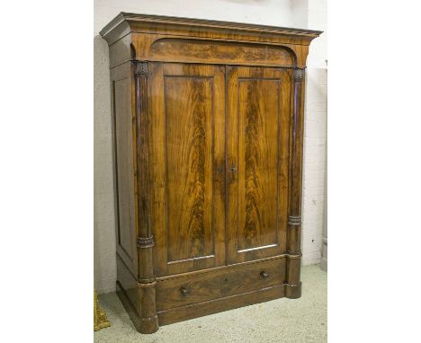 ARCHITECTURAL WARDROBE, mid 19th century flame mahogany with two well figured panelled doors enclosing double hanging space, 
