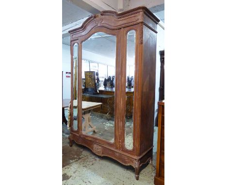 ARMOIRE, 19th century French walnut and partially distress pink painted with a central arched mirrored door flanked by bevell