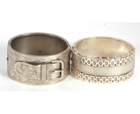 A Victorian silver bangle and a buckle bangle, the Victorian silver bangle with Etruscan revival style decoration to upper ha