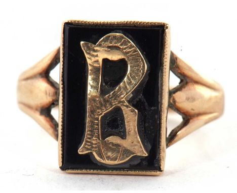 An onyx signet ring, the rectangular plaque with the initial R, with split shoulders and plain band stamped '9ct', size S, 4.