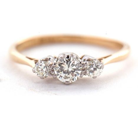 An 18ct three stone diamond ring, the three round brilliant cut diamonds, total estimated approx. 0.39cts, all claw mounted t