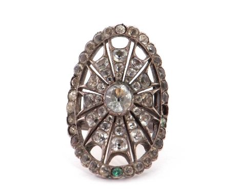 A Georgian style paste set ring, the curved oval set with white paste stones, all set in white metal (tests as silver) with a