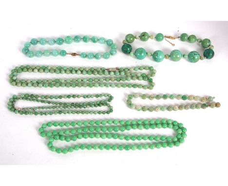 A quantity of jade and similar green bead necklaces, to include a carved jade bead necklace, a jade, turquoise and malachite 