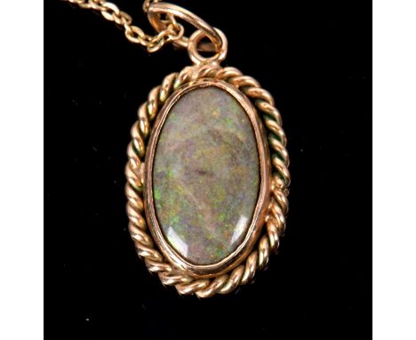 A boulder opal necklace, the oval boulder opal cabochon in a rubover mount with rope twist border of unmarked yellow metal (t
