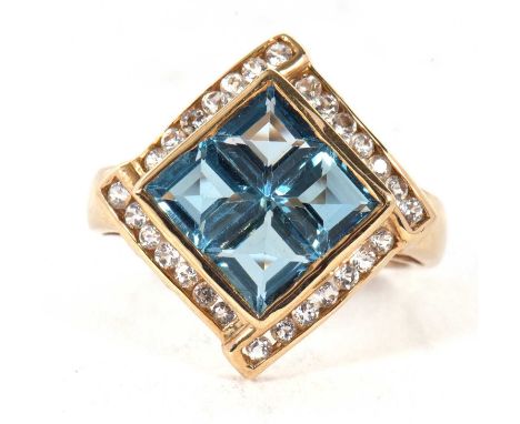A 9ct topaz ring, the four square step cut topaz in a collet mount, surrounded by small round white stones, with a pierced ga