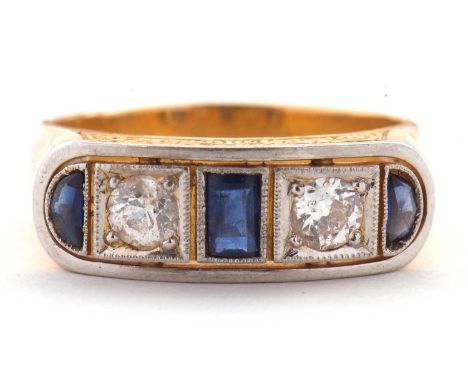 An 18k sapphire and diamond ring, the mixed cut sapphires and diamonds in a lozenge shaped plaque with curved ends and milleg