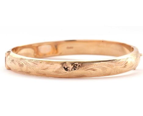 A 9ct hinged bangle, the upper half with engraved decoration and lower half plain, stamped 375 to both halves and hallmarked 