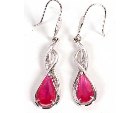 A pair of 14ct ruby and diamond earrings, the pear shape rubies in a twisted crossover mount set with small round diamonds, 3