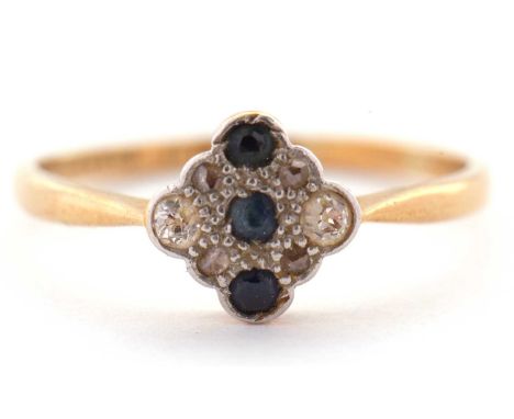An 18ct and platinum sapphire and diamond ring, the three verticaly set round sapphires set within an diamond shaped plaque s