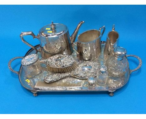 Silver plated tea set, four silver topped jars and bottles, a silver brush, comb and mirror