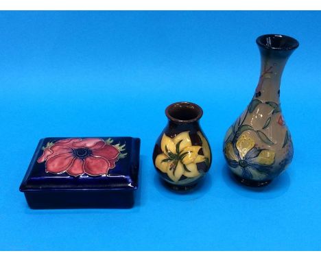 A Moorcroft rectangular trinket box and two Moorcroft vases, 16cm and 9cm high