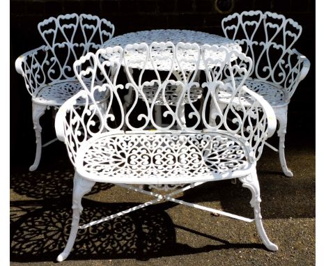 A white painted cast aluminium patio set, comprising a two seater bench, 90cm wide, a table 78cm wide, and pair of chairs.&nb