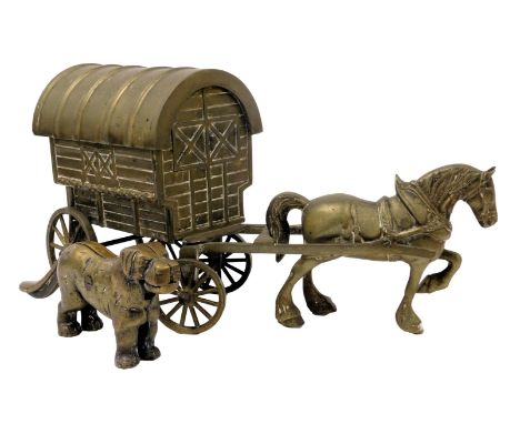 A brass model of a horse drawn gypsy caravan, 52cm wide, together with a brass nutcracker modelled as a dog, 29cm wide. (2)