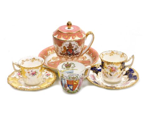Two early 20thC Coalport porcelain coffee cups and saucers, decorates with reserves of flowers, gilt heightened, one against 