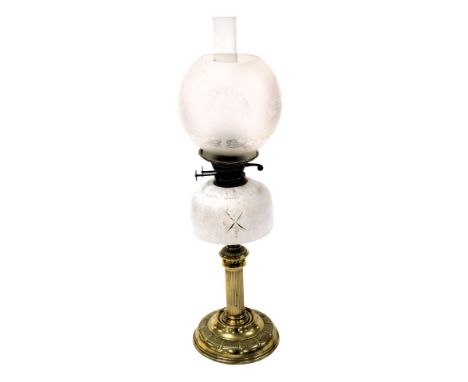 An early 20thC brass oil lamp, of fluted column form, with an opaline glass reservoir, glass chimney and floral etched glass 