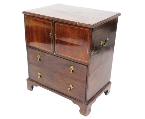 A George III mahogany commode, with boxwood line inlay, with two doors, above a two dummy drawer, opening to reveal a vacant 