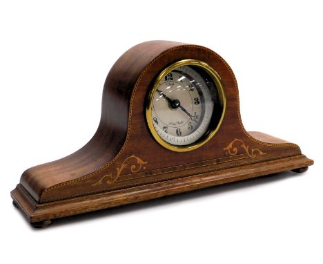 An Edwardian mahogany and inlaid mantel clock, with later battery movement, the case of Napoleon hat form, raised on brass fe