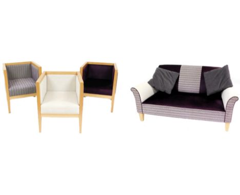 A Wisley light beech four piece suite, upholstered in cream and purple chequer board and plain fabric, comprising a two seate