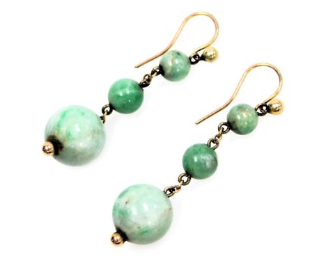 A pair of graduated three stone jade drop earrings, on a fish hook clasp.