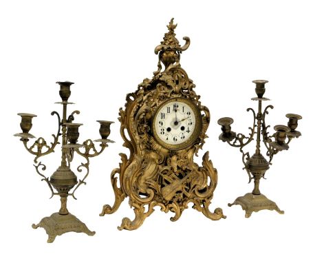A late 19thC French brass cased mantel clock, circular enamel dial bearing Arabic numerals, eight day movement, with bell str