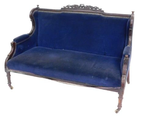 A Victorian mahogany two seater sofa, upholstered in blue velvet, raised on turned legs, brass capped on castors, 138cm wide.