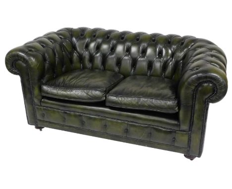 A green leather two seater Chesterfield sofa, with button back, and loose cushion seats, 170cm wide.The upholstery in this lo